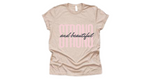 Tan short sleeved t-shirt with "strong and beautiful" quote in pink and black lettering
