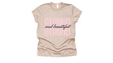 Tan short sleeved t-shirt with "strong and beautiful" quote in pink and black lettering