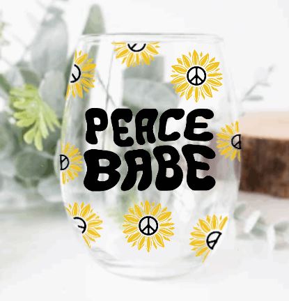 Stemless wine glass with "peace babe" text and sunflower graphics